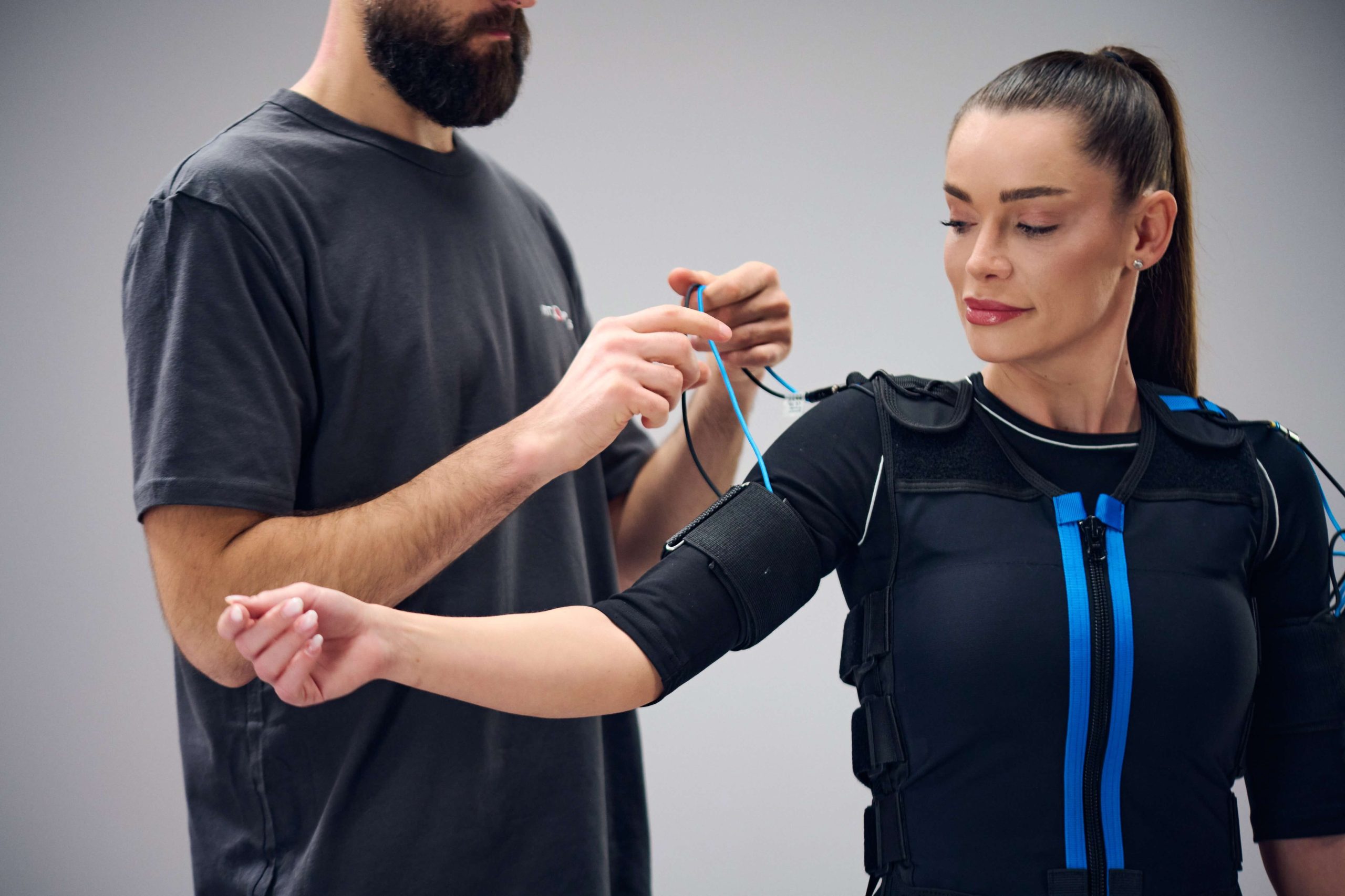 woman putting on the ems device - cellulite photo